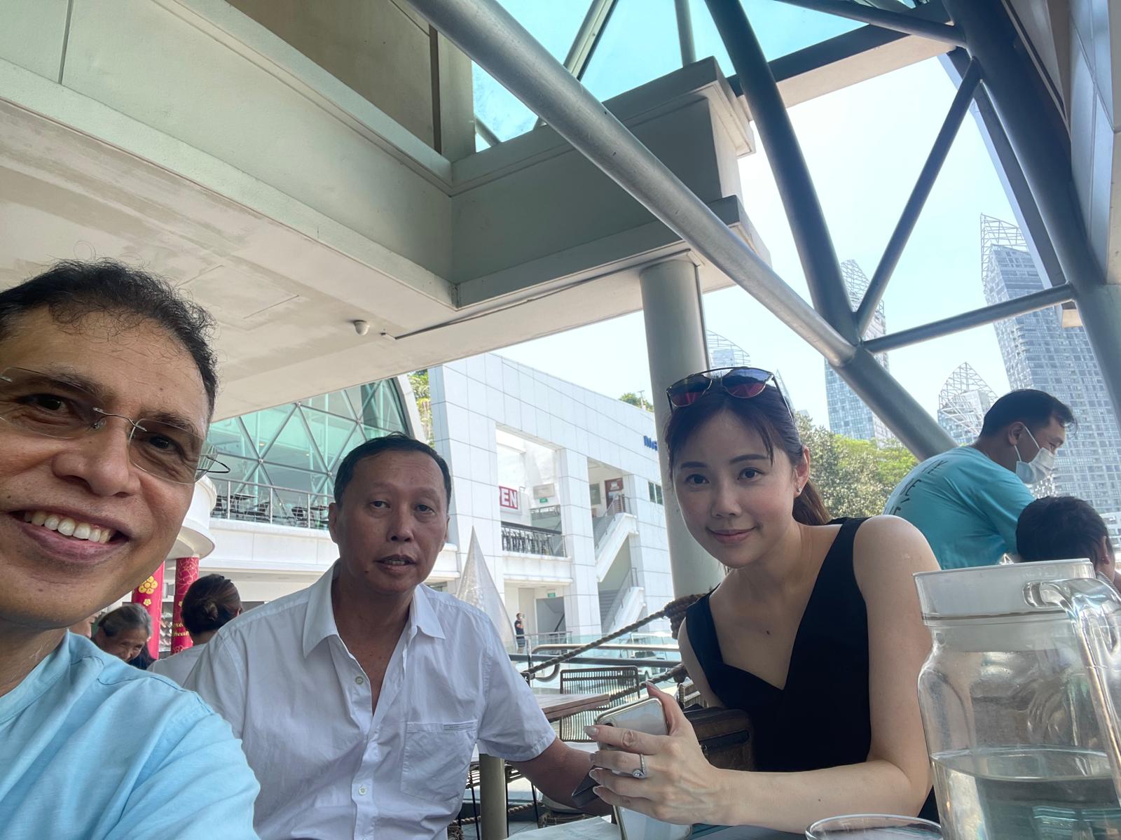 Chan with clients at an outdoor meeting